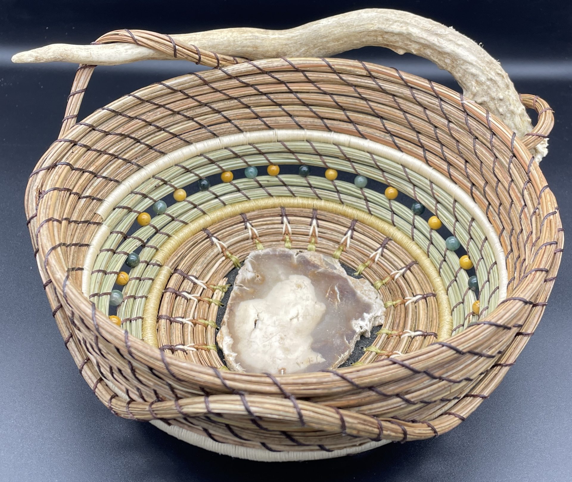 Petrified wood base basket with deer antler