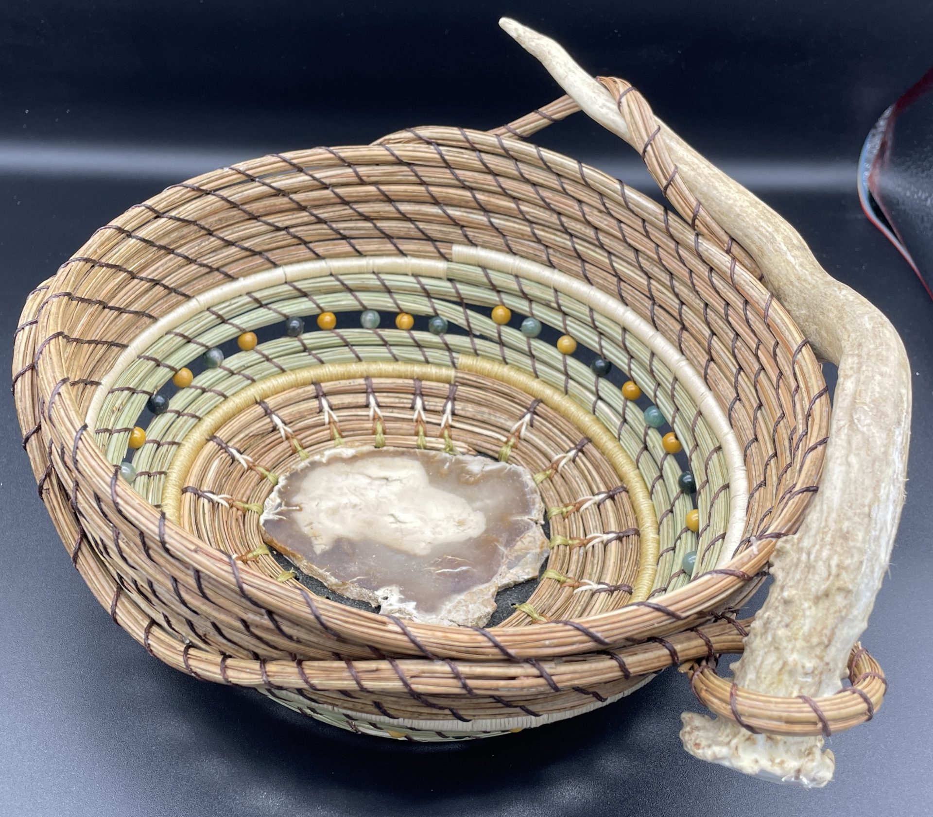 Petrified wood base basket with deer antler